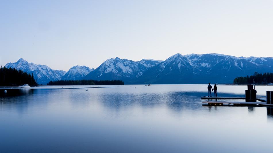 Couple on beautiful lakeshore at mountains