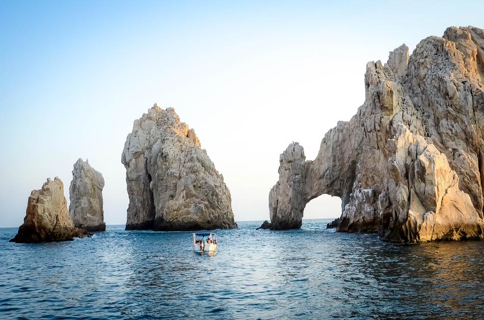 boat near rocky formations in the sea