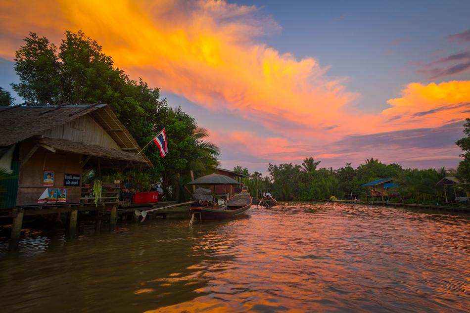 flag on a wooden hut near the river in thailand