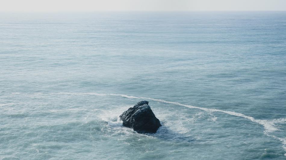 black rock in the tropical ocean