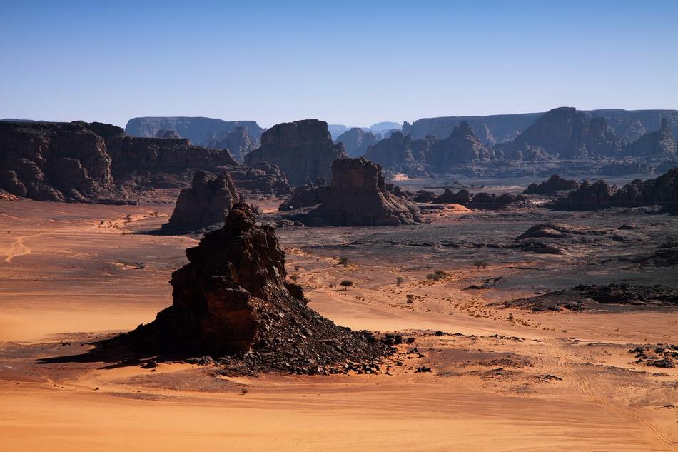 Beautiful and colorful landscape of N'ajjer with rocks among the sand, in Algeria, Africa, under the blue sky