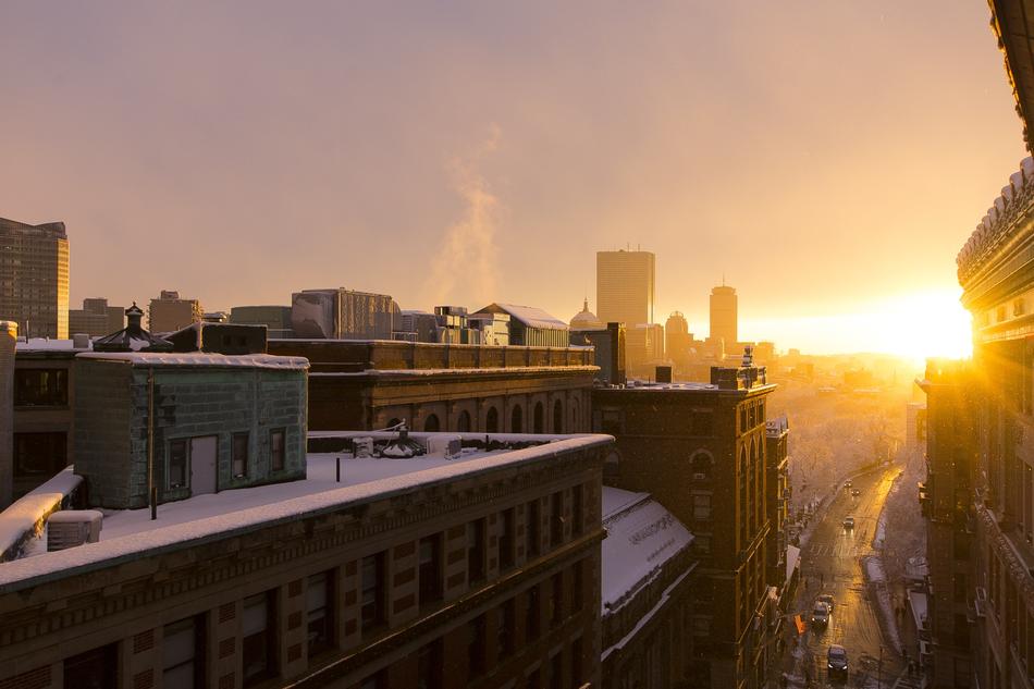 Beautiful cityscape with the buildings in snow, at beautiful golden sky, in the winter
