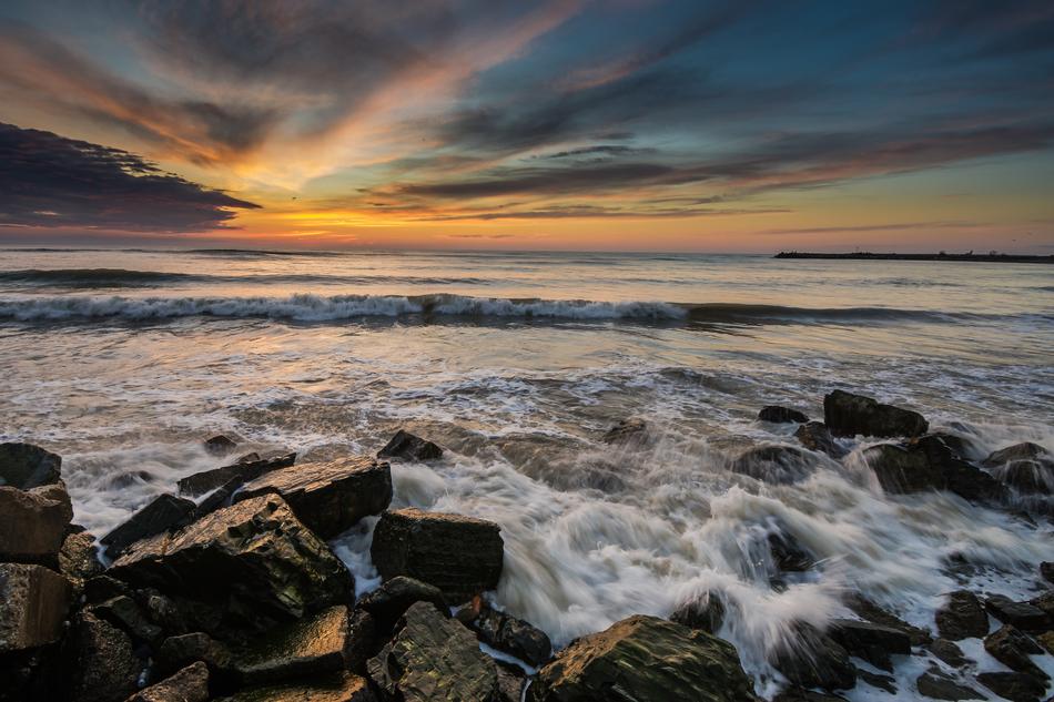 Beautiful, rocky beach of the Black Sea in Romania, at colorful and beautiful sunrise
