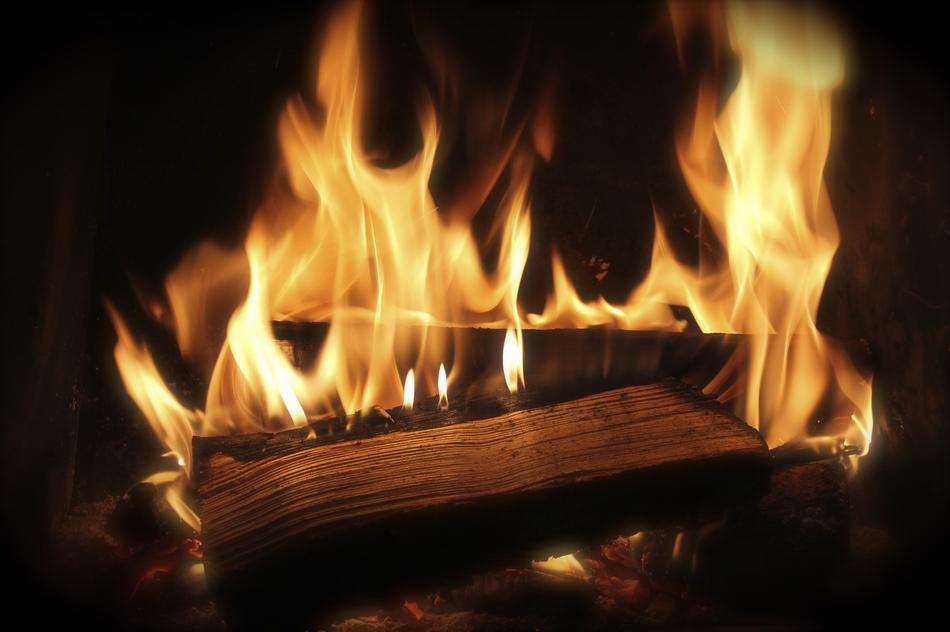 stack of Firewood burning in darkness