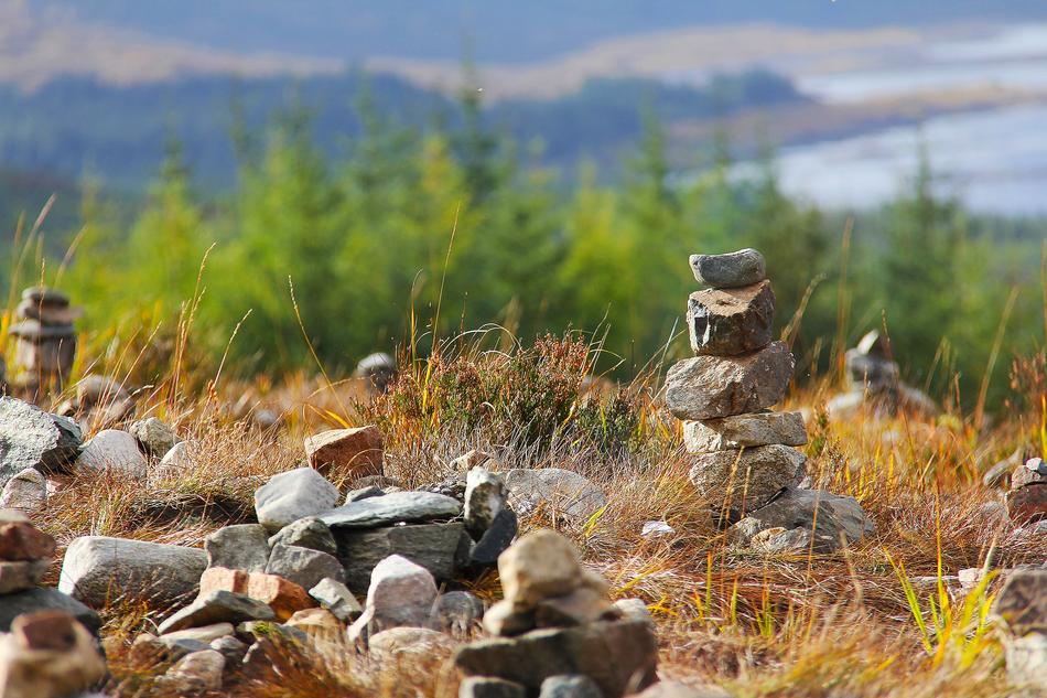 stones on a hill with green grass on the isle of skye