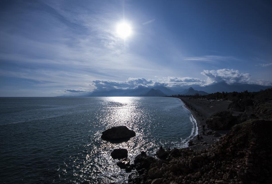 Beautiful landscape of the beach, near the water with ripple, in sunlight