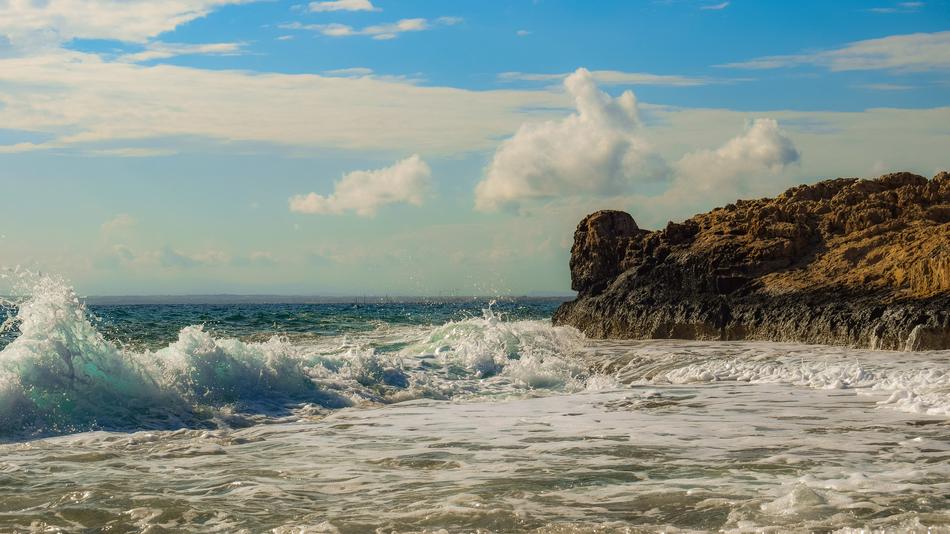 Rocky Coast at Waves of Sea