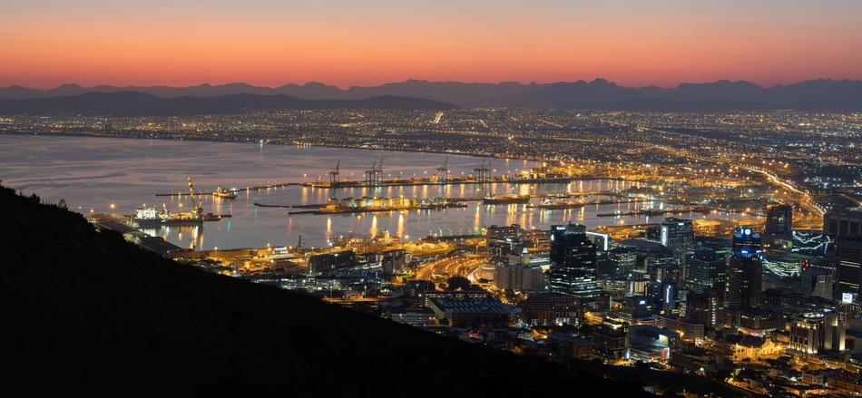 view of the city near the sea during sunrise