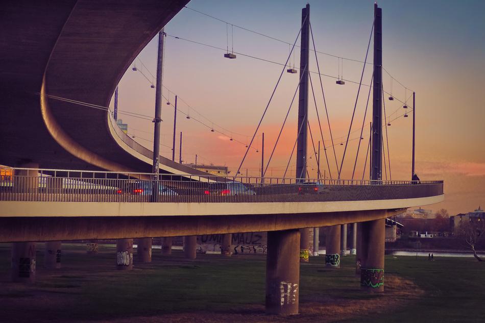 cars on the bridge at dusk in the city