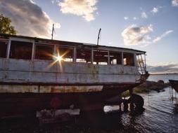 old Wrecked ship on beach at sunset