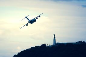 Aircraft flying above the beautiful GellÃ©rt Hill in Budapest, Hungary, at colorful sunset