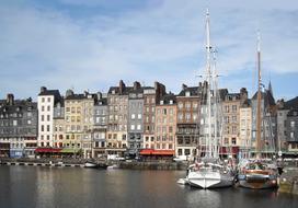 Beautiful and colorful houses and boats in the port of Honfleur, Normandy, France