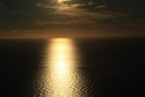 Waterscape at gold dusk, under the dark clouds, in Canada