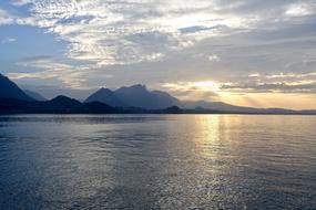 Beautiful landscape with the sea coast with mountains, at colorful and beautiful sunset with clouds