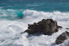 stones in sea waves with splashes
