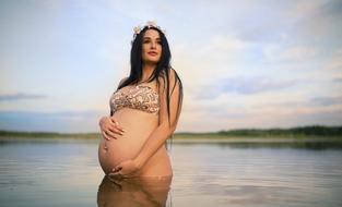 pregnant woman posing in water