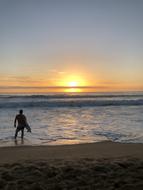 Surfer on Beach at Sunrise