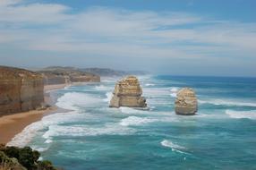 Beautiful and colorful landscape with the Twelve Apostles near the sandy beach with cliffs in Australia