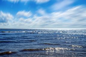 white blurred clouds over sea waves