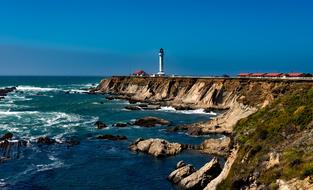 Beautiful landscape with the Point Arena Lighthouse on the colorful cliffs, in California, USA under the blue sky