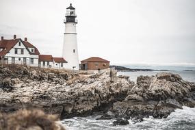 houses and lighthouse on the rocky coast