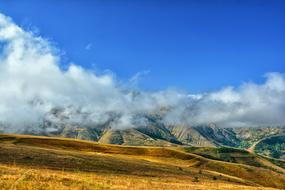Landscape of the beautiful and colorful KaÃ§kars mountains in Turkey, in clouds, under the blue sky
