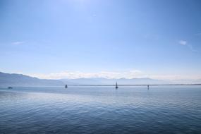 Beautiful landscape of the sea, with boats, among the mountains, in sunlight