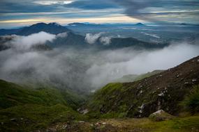 panoramic view of mountain landscape in fog on cloudy day