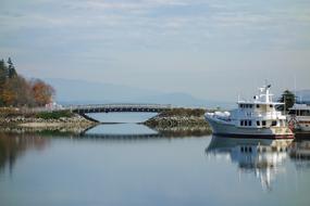 distant view of the white yacht near the bridge