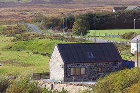 Beautiful and colorful landscape of Scotland Highlands, with houses and plants