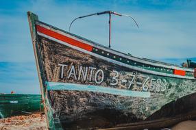 sea boat with lettering on the beach close up