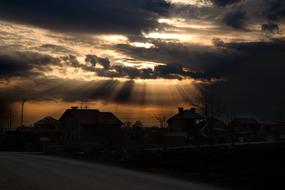 Sunset, Sun Rays bursting through dark clouds