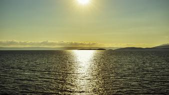 reflection of the sun on the sea surface in Pagasitikos Gulf, Greece