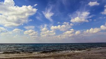 white clouds over the sea coast on a sunny day