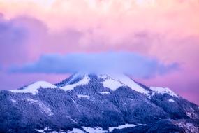 Beautiful landscape of the mountains in snow, in France, at colorful and beautiful sunset with clouds