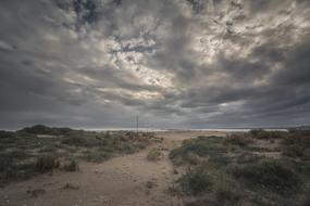 gray clouds over desert landscape