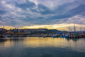 Beautiful landscape of the beach with boats, at colorful and beautiful sunset in clouds