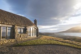 stone bungalow on the coast on a cloudy day