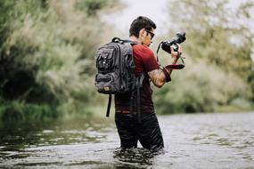 photographer with a camera in the water