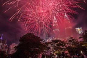 pink fireworks over city architecture