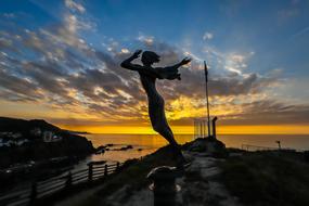 Silhouette The Statue Of female at Sunset