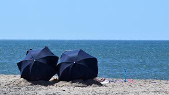 Parasol Sunbathing on sand beach