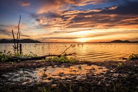 colorful Sunset sky mirroring on wet beach