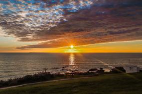 sunset in gray clouds over the coast of england