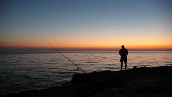 fisherman silhouettes on the seaside