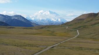 long trail through valley to snowy Mountain, scenicLandscape