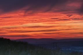 Beautiful landscape with silhouettes and mountains, at colorful and beautiful sunset with clouds