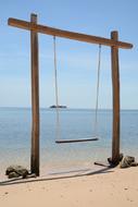 wooden swing on the coast of indonesia