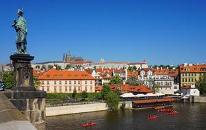 Beautiful and colorful buildings and castle in Prague, Czech Republic, in sunlight, under the blue sky