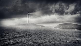 black and white photo of fog over the sea